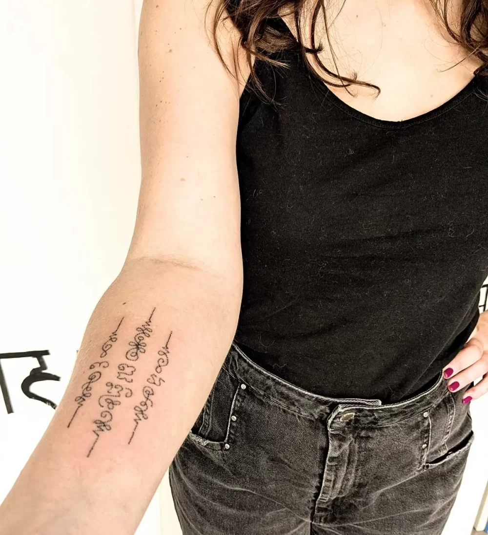 Tatouage thaïlandais Sak Yant sur l'avant-bras, écriture khom sacrée, réalisé au handpoke
